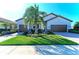 Charming single-Gathering home with well-manicured lawn and brick driveway, plus two-car garage at 324 Whispering Palms Ln, Bradenton, FL 34212