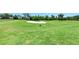 Expansive golf course featuring lush green fairways, a sand trap, and beautiful scenery at 324 Whispering Palms Ln, Bradenton, FL 34212