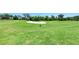 View of the golf course with vibrant green grass and a white sand trap on a sunny day at 324 Whispering Palms Ln, Bradenton, FL 34212