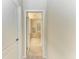 Hallway view leading into the bathroom, with tiled floors and neutral wall paint at 324 Whispering Palms Ln, Bradenton, FL 34212