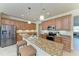 Kitchen features granite countertops, stainless steel appliances, and seating at the island at 324 Whispering Palms Ln, Bradenton, FL 34212