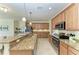 A bright kitchen with stainless steel appliances, granite counters, and wood cabinets at 324 Whispering Palms Ln, Bradenton, FL 34212