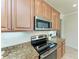 Modern kitchen featuring stainless steel appliances and granite countertops with lots of cabinet space at 324 Whispering Palms Ln, Bradenton, FL 34212