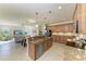 Open kitchen with granite countertops, stainless steel appliances, and seamless flow to living area at 324 Whispering Palms Ln, Bradenton, FL 34212