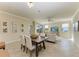 Open living room with dining table, tile floors, and comfortable seating area with lots of natural light at 324 Whispering Palms Ln, Bradenton, FL 34212