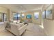 Inviting living room with access to the lanai and views of the lake at 324 Whispering Palms Ln, Bradenton, FL 34212