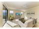 Bright living room featuring a ceiling fan and sliding glass doors to the lanai at 324 Whispering Palms Ln, Bradenton, FL 34212