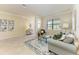 Spacious living room featuring tile floors, comfortable seating, and lots of natural light at 324 Whispering Palms Ln, Bradenton, FL 34212