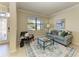 Cozy living room with plush seating, stylish decor, and a sunlit window at 324 Whispering Palms Ln, Bradenton, FL 34212