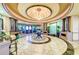 Bright lobby features elegant pillars, tile flooring, and a decorative ceiling with a chandelier at 324 Whispering Palms Ln, Bradenton, FL 34212