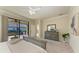 Bright main bedroom with sliding door access to the lanai and ensuite bathroom at 324 Whispering Palms Ln, Bradenton, FL 34212