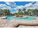 A tranquil view of the pool with lounge chairs and shade at 324 Whispering Palms Ln, Bradenton, FL 34212