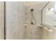 Tiled shower with shower head, soap dishes and grab bar in neutral tones at 324 Whispering Palms Ln, Bradenton, FL 34212