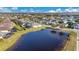 Scenic aerial view of a lake with a reflection of a house within a community, with a walking path at 3831 Creekside Park Dr, Parrish, FL 34219
