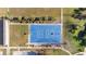Aerial view of a well-maintained outdoor blue basketball court surrounded by green spaces and walking paths at 3831 Creekside Park Dr, Parrish, FL 34219