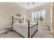 Inviting bedroom with iron frame bed, soft carpet, and natural light from the window at 3831 Creekside Park Dr, Parrish, FL 34219