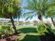 Scenic backyard with a peaceful pond view and lush tropical landscaping at 4155 Cascade Falls Dr, Sarasota, FL 34243