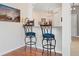 Stylish bar area with granite countertops, elegant bar stools, and ample space for entertaining guests at 4155 Cascade Falls Dr, Sarasota, FL 34243
