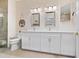 Elegant bathroom with dual sinks, vanity with ample storage, and modern lighting at 4155 Cascade Falls Dr, Sarasota, FL 34243