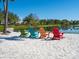 Beach with colorful Adirondack chairs overlooking tranquil lake at 4155 Cascade Falls Dr, Sarasota, FL 34243