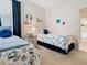 Inviting bedroom with twin beds, beach-themed decor, and a cozy, comfortable feel at 4155 Cascade Falls Dr, Sarasota, FL 34243