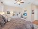 Serene bedroom featuring a plush bed, dresser, wood floors, and ceiling fan at 4155 Cascade Falls Dr, Sarasota, FL 34243