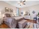 Inviting bedroom featuring a plush bed, stylish decor, warm wood floors and a ceiling fan at 4155 Cascade Falls Dr, Sarasota, FL 34243