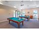 Community billiard room with pool tables, ceiling fans, and large windows at 4155 Cascade Falls Dr, Sarasota, FL 34243