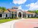 Beautiful clubhouse exterior features lush landscaping, elegant architecture, and inviting entrance, perfect for community gatherings at 4155 Cascade Falls Dr, Sarasota, FL 34243