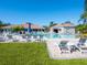 Resort-style community pool with ample lounge chairs, clear blue water, and lush landscaping for relaxing poolside at 4155 Cascade Falls Dr, Sarasota, FL 34243