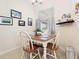 Bright dining area features a wood table, four chairs, natural light, and lovely decor at 4155 Cascade Falls Dr, Sarasota, FL 34243