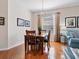 Charming dining area with wood table and chairs, stylish light fixture, and ample natural light from the window at 4155 Cascade Falls Dr, Sarasota, FL 34243