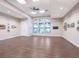 Spacious community gallery featuring contemporary artwork, hardwood floors, and an abundance of natural light at 4155 Cascade Falls Dr, Sarasota, FL 34243