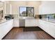 Community kitchen featuring modern appliances, white cabinetry, and a beautiful view of the community at 4155 Cascade Falls Dr, Sarasota, FL 34243
