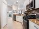 Modern kitchen with stainless steel appliances, granite countertops, and white cabinetry, offers a great cooking space at 4155 Cascade Falls Dr, Sarasota, FL 34243