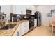 Well-equipped kitchen features stainless appliances, granite countertops, and updated white cabinetry at 4155 Cascade Falls Dr, Sarasota, FL 34243