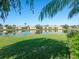 Enjoy serene lake views from this property, complete with lush green landscaping and clear blue skies at 4155 Cascade Falls Dr, Sarasota, FL 34243