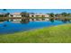 This home offers scenic waterfront views with a peaceful lake reflecting the blue sky and surrounding greenery at 4155 Cascade Falls Dr, Sarasota, FL 34243