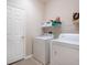 Functional laundry room with washer, dryer, and storage shelving for convenience at 4155 Cascade Falls Dr, Sarasota, FL 34243