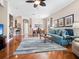 Spacious living room with wood floors, an open floor plan, elegant dining set, and comfortable seating arrangement at 4155 Cascade Falls Dr, Sarasota, FL 34243