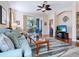 Comfortable living room featuring wood floors, a modern ceiling fan, and sliding glass doors to the outdoor patio at 4155 Cascade Falls Dr, Sarasota, FL 34243