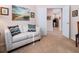 Comfortable living area with a stylish couch, artwork, and an open view to the kitchen at 4155 Cascade Falls Dr, Sarasota, FL 34243