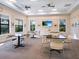 Light-filled multi-purpose room with tables, chairs, a large screen television, and bright windows at 4155 Cascade Falls Dr, Sarasota, FL 34243