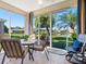 Bright sunroom with views of the lush landscaping and tranquil pond at 4155 Cascade Falls Dr, Sarasota, FL 34243