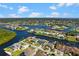 Aerial view of the waterfront community showcases the home's location on the canal with a pool at 4196 Eastlake Ct, Port Charlotte, FL 33948