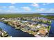 Aerial view of waterfront community with beautiful home and pool on the canal at 4196 Eastlake Ct, Port Charlotte, FL 33948