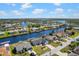 Scenic aerial view of waterfront homes along canals, offering boating access and picturesque neighborhood scenery at 4196 Eastlake Ct, Port Charlotte, FL 33948
