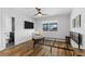 Bedroom featuring hardwood floors, ceiling fan, and a large picture window at 4196 Eastlake Ct, Port Charlotte, FL 33948