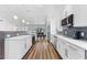 Clean white kitchen with long countertops, stainless appliances, and tile backsplash at 4196 Eastlake Ct, Port Charlotte, FL 33948