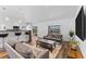 Bright living room featuring modern furniture and open access to the kitchen at 4196 Eastlake Ct, Port Charlotte, FL 33948